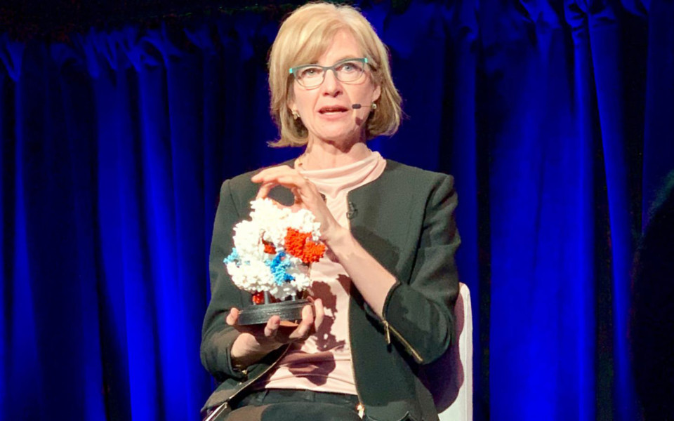 Image of Doudna holding a 3D model of CRISPR