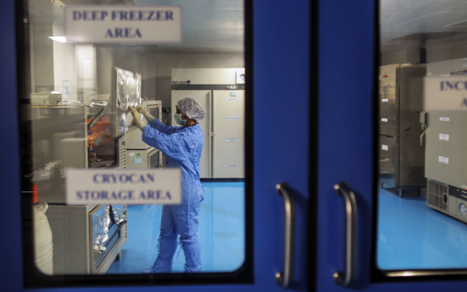 Image of scientist in lab deep freezer area