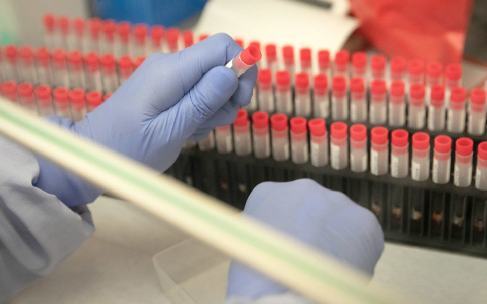 Image of scientist handling vials