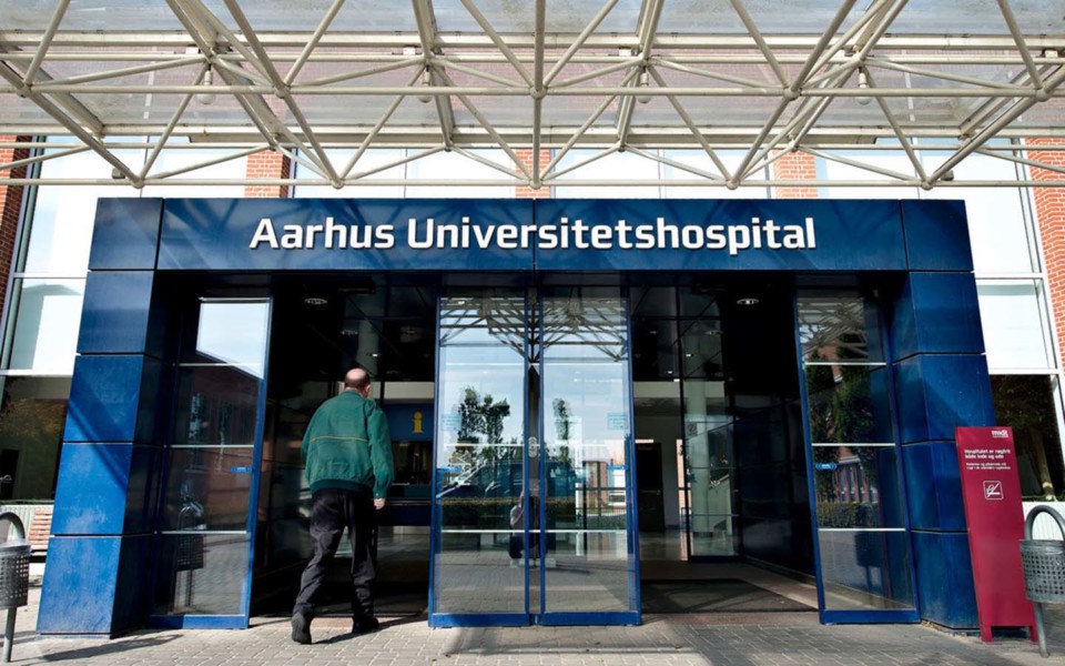 Image of man walking into Aarhus University Hospital in Denmark