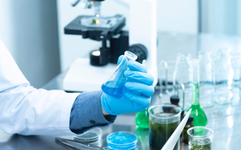 Image of scientist holding a flask in lab