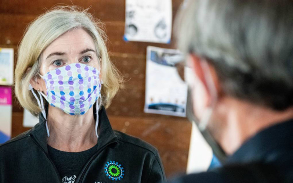 Image of Jennifer Doudna wearing a mask and talking about the Innovative Genomics Institute's COVID-19 saliva testing